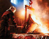 Foundry worker pouring metal