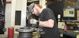 Manufacturing worker checking metal part