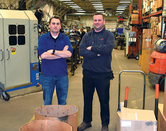 Western Spring brothers pose in their manufacturing facility