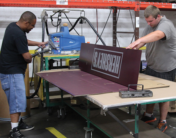 Tilsner Carton employees assemble a point of sale display