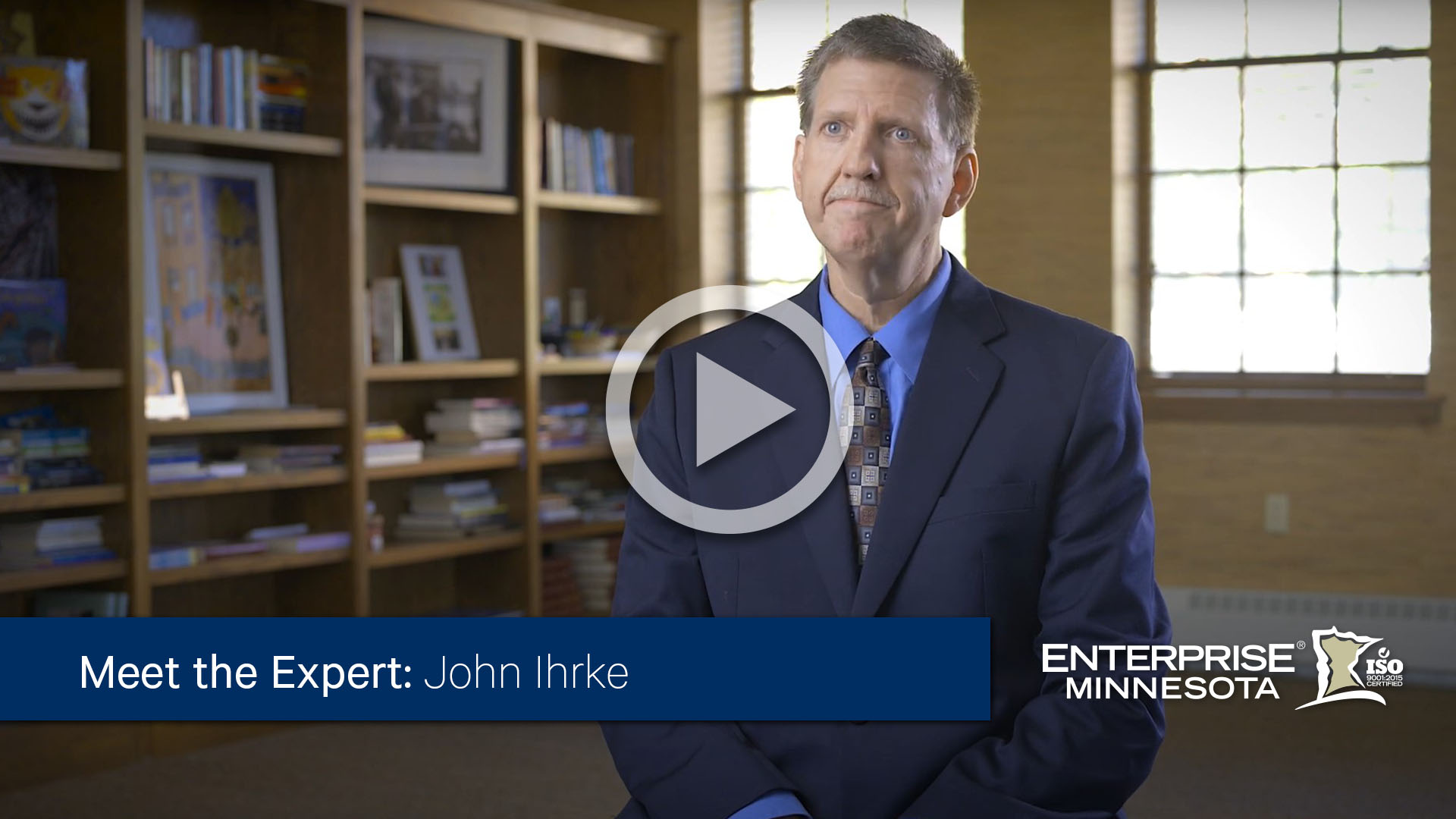 John Ihrke sitting in a chair. Click to watch his bio video. 