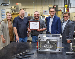 Owners at Excelsior Tool posing with Enterprise MN staff.