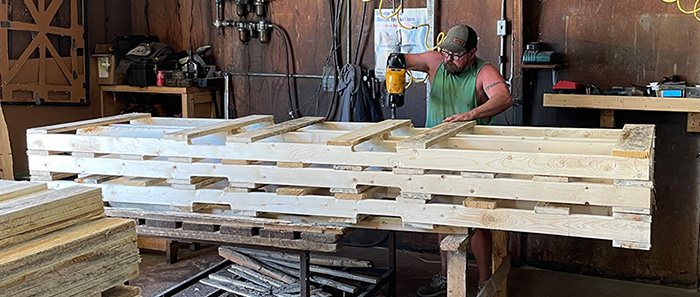 Nailing together pallets at Popp Brothers Lumber