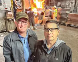 Joe Plunger and Jeff Hoch standing in front of molten metal