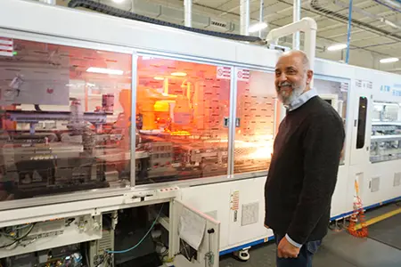 CEO Martin standing at a production machine