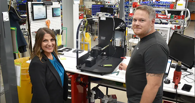 Senior Instrument Lead MattRobertson and Site Director Kristen Berg with a module of the Nexar liquid handler in Instrument Production.