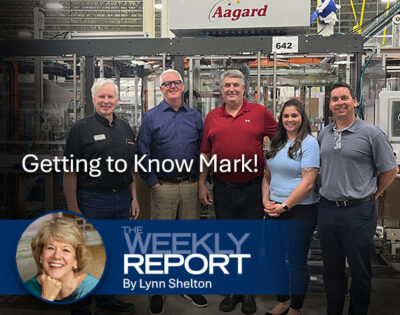 Mark O'Leary standing with other tour participants at Aagard in Alexandria, Minnesota. Overlaid on the image is the text "The Weekly Report".