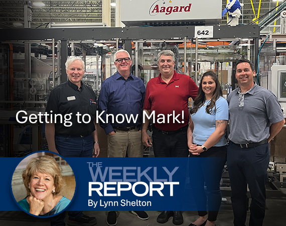 Mark O'Leary standing with other tour participants at Aagard in Alexandria, Minnesota. Overlaid on the image is the text "The Weekly Report".