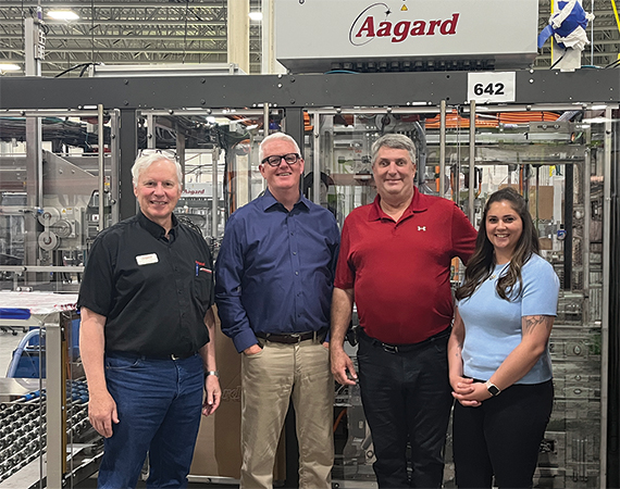 Mark O'Leary, Senator Torrey Westrom, and Aagard leadership standing together on the company's manufacturing floor.